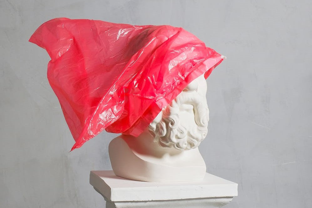 Red Plastic Bag on Statue