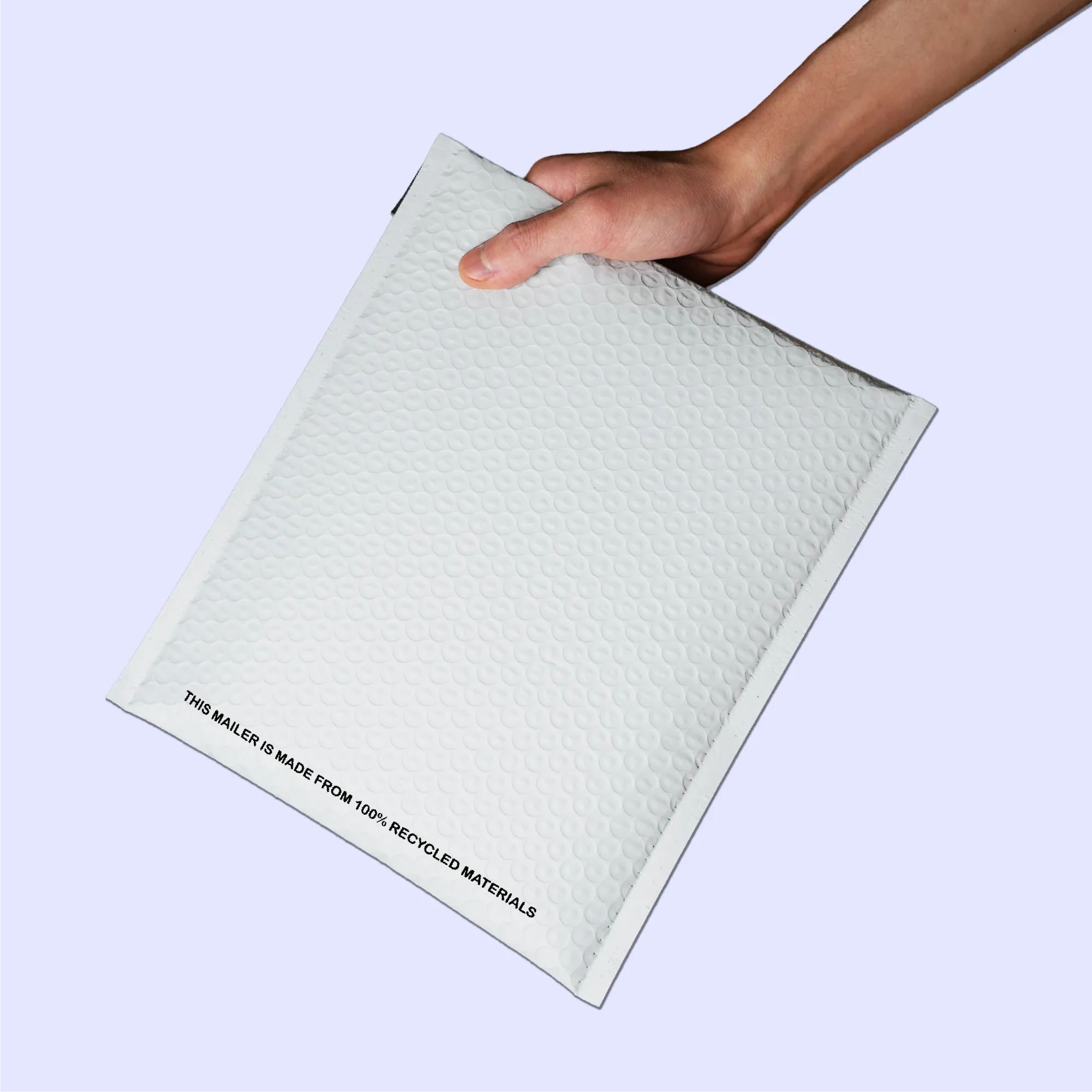 White poly shipping envelope held by hand