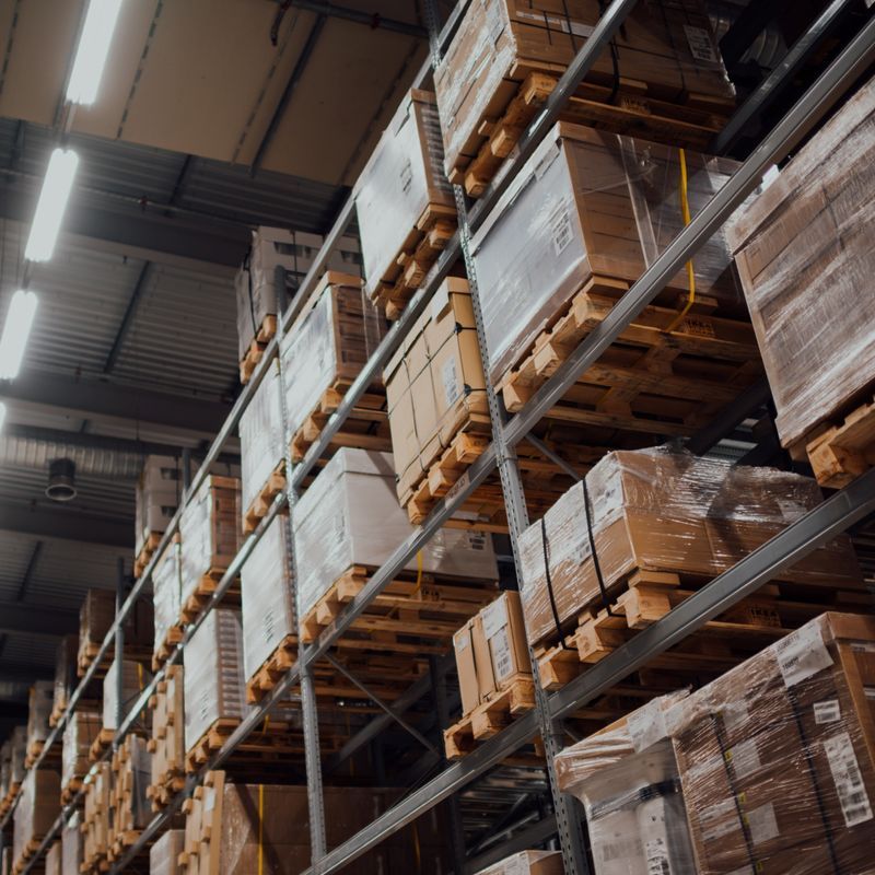 Pallets of packaging loaded in warehouse shelves